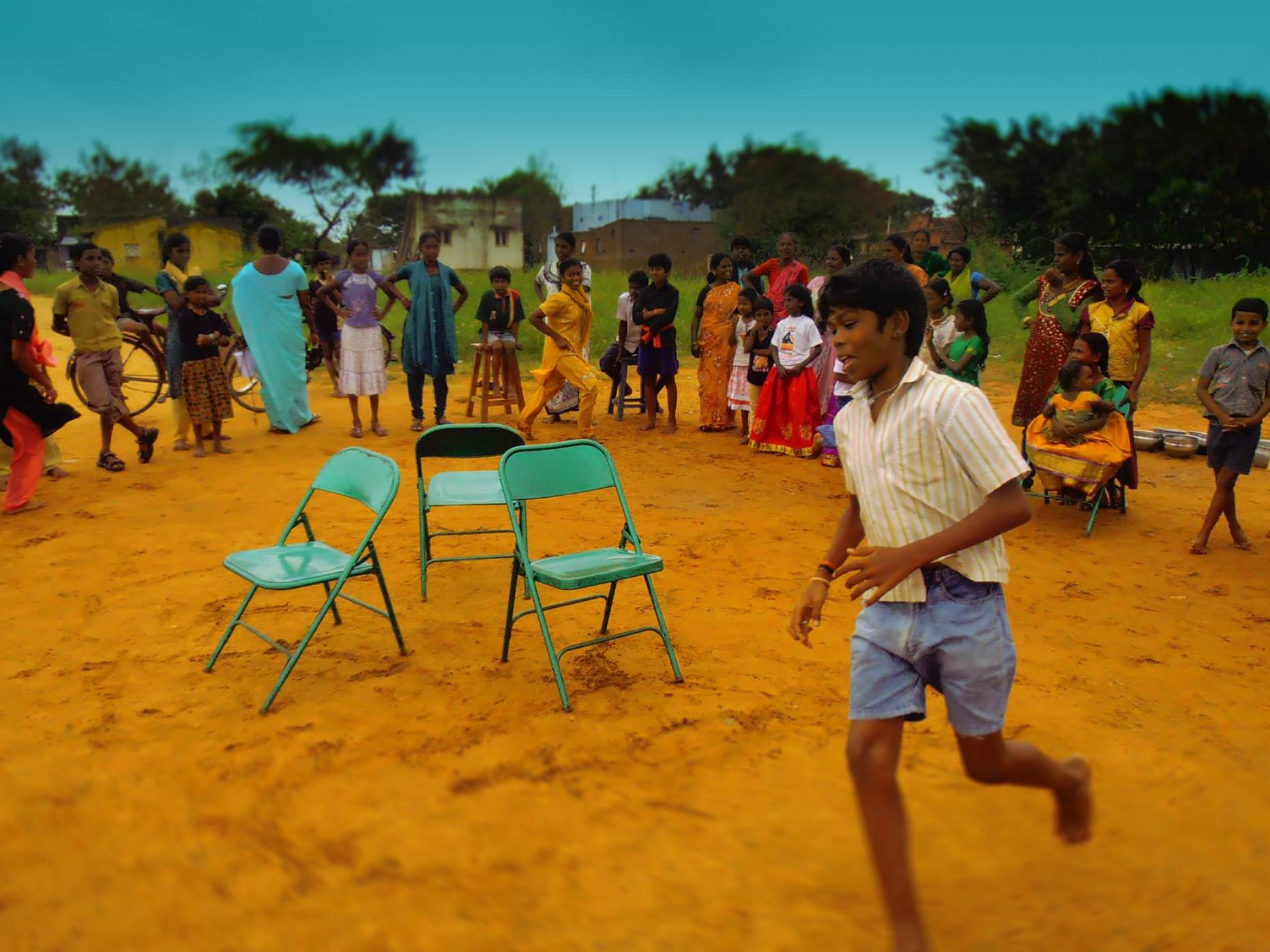 Happy onlookers watch a child playing a game